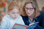 child-reading-with-teacher